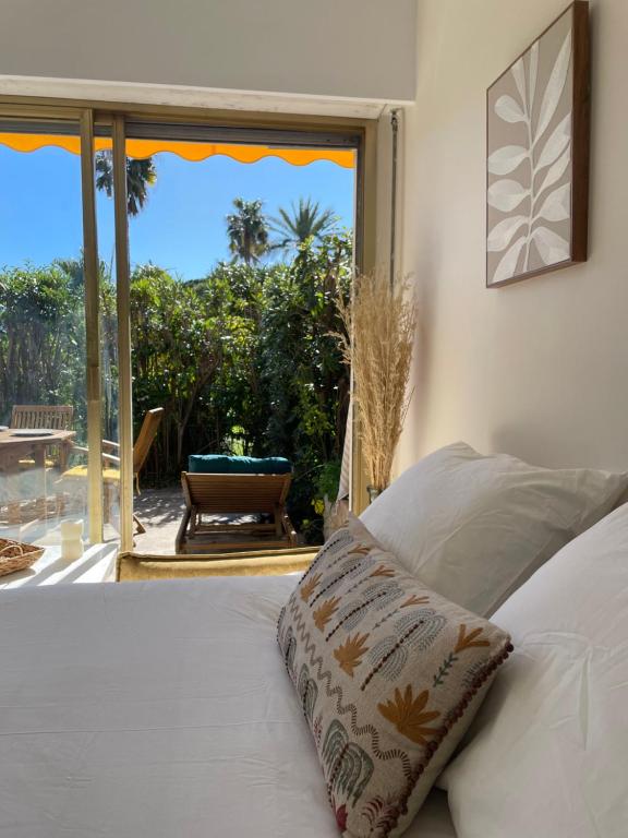 - une chambre avec un lit et une vue sur une terrasse dans l'établissement Le Week Riviera III -3 étoiles-Plage du midi-Grande terrasse-Piscine-Cannes- Palais des Festivals, à Cannes