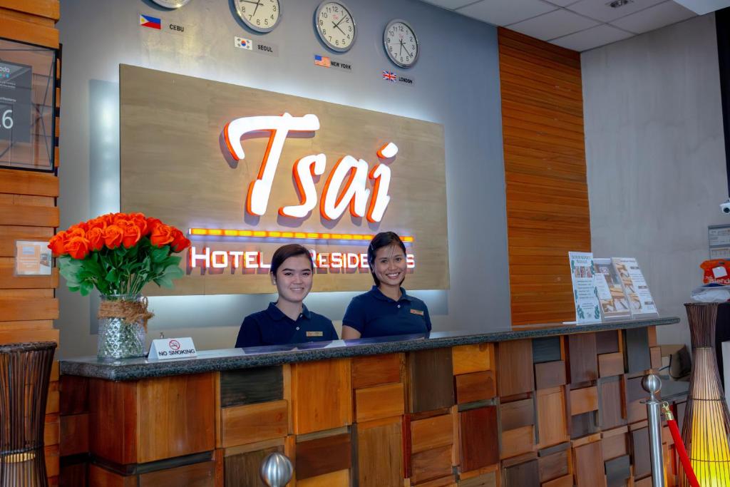 two people sitting at a counter in a restaurant at Tsai Hotel and Residences in Cebu City