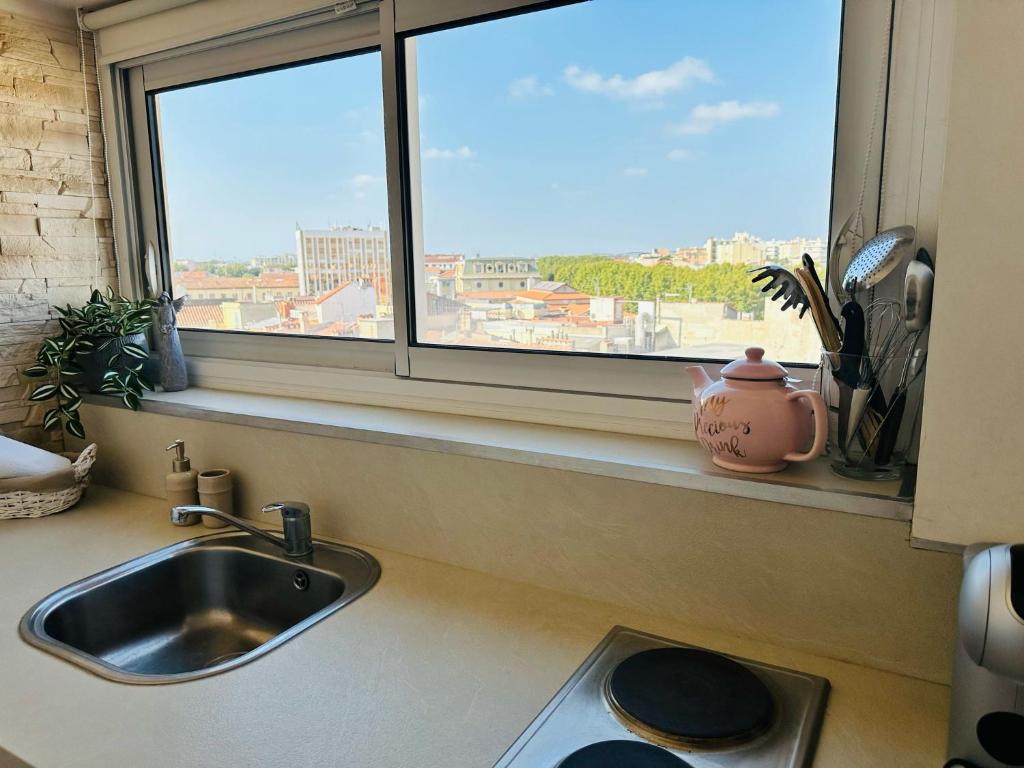 a kitchen counter with a sink and a window at studio de charme in Perpignan