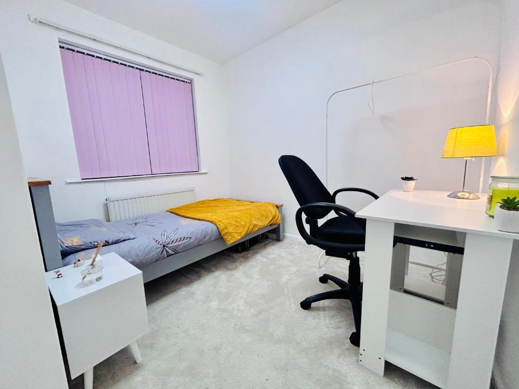 a bedroom with a bed and a desk and a chair at Room in Oldham, Manchester in Oldham