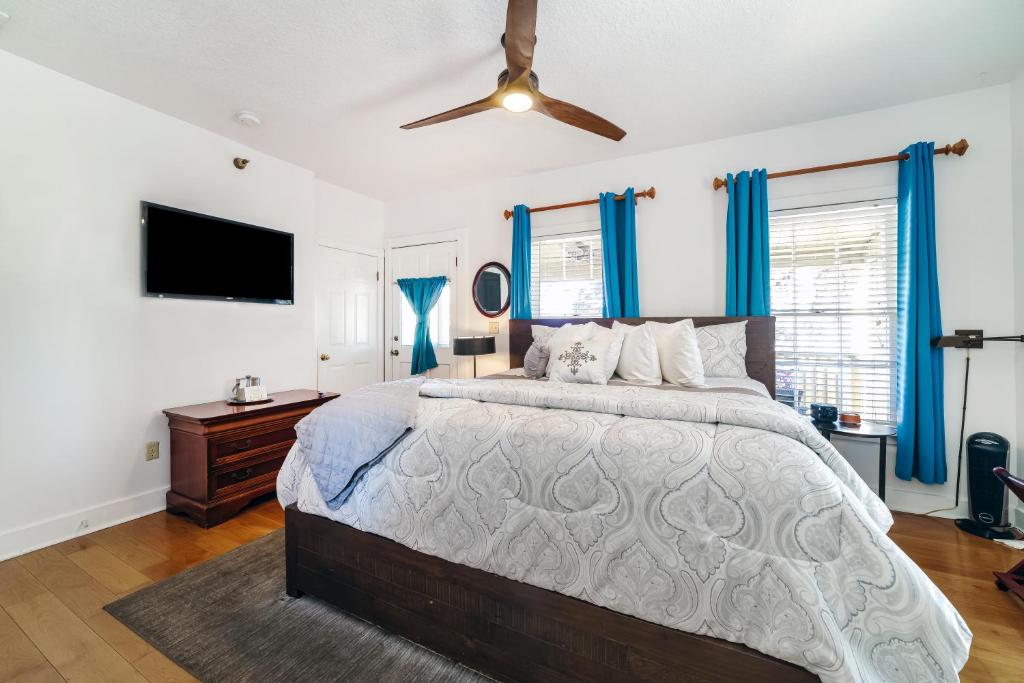 a bedroom with a large bed and a flat screen tv at Agustin Inn - Saint Augustine - Adults Only in St. Augustine