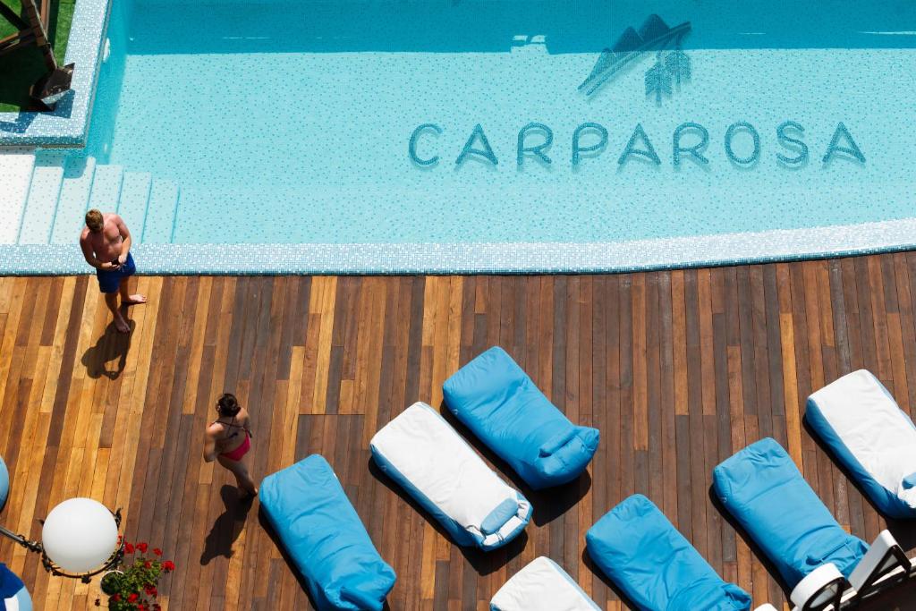 an overhead view of a swimming pool with blue pillows at Carparosa Hotel in Bukovel