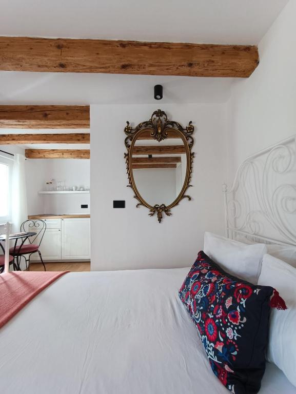 a bedroom with a bed and a mirror on the wall at M&R Apartments II in Koper