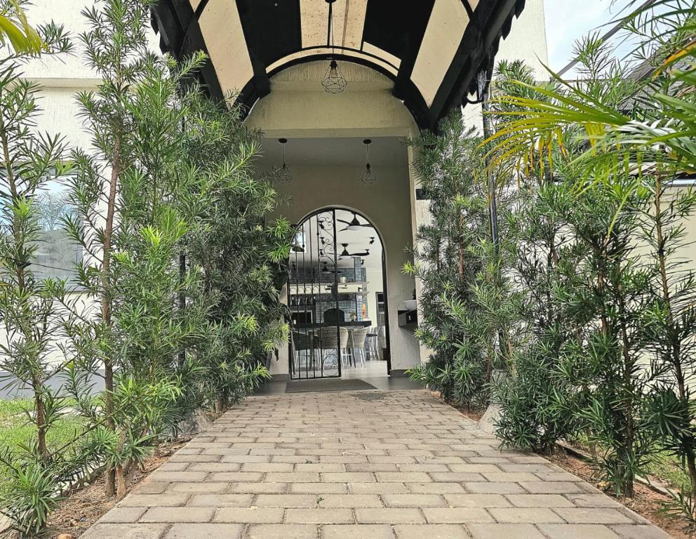 an entrance to a building with a brick walkway at Hotel Oasis-Dream Holidays - La Petite France in San Bernardino