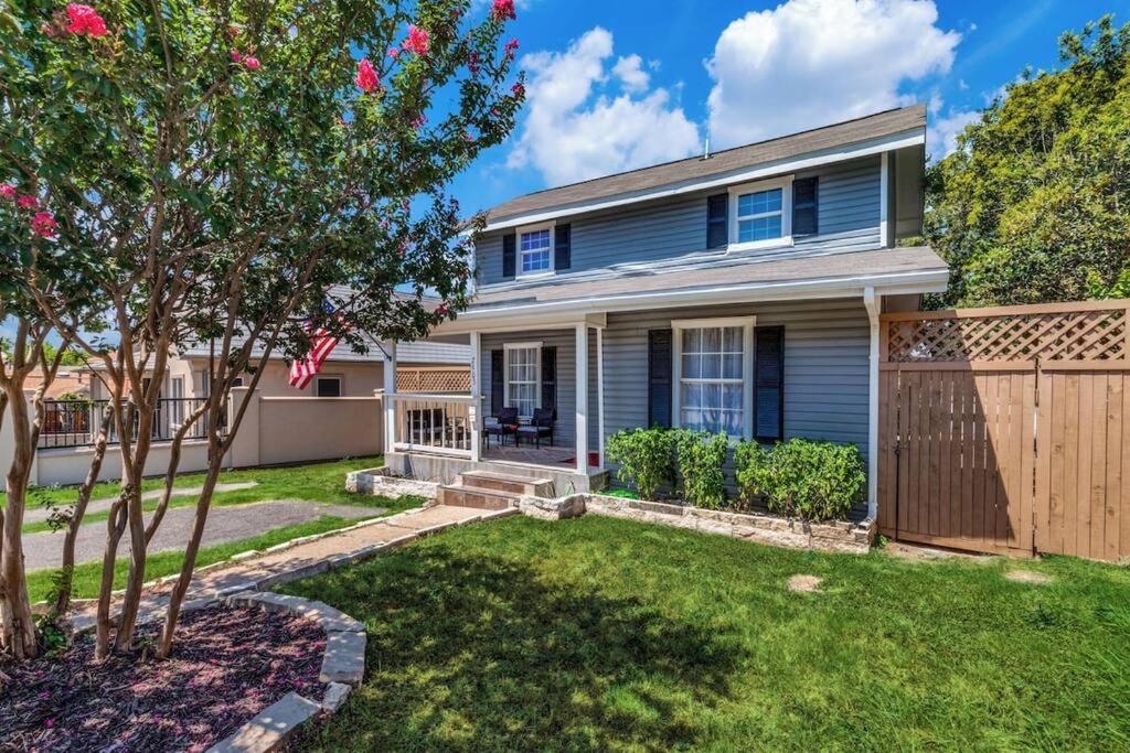 a blue house with a fence and a yard at StockYards-BBobs-4mins! GrayLee House.4-Bedrooms in Fort Worth