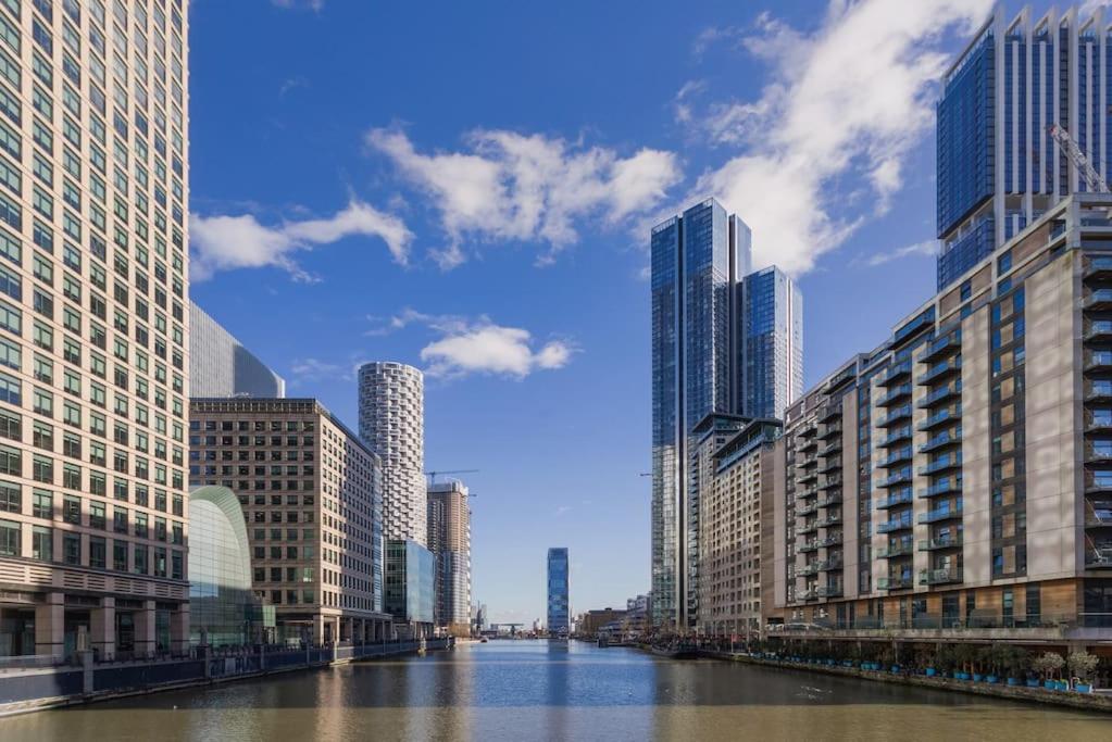 a view of a river in a city with tall buildings at New Luxury Close to Central London entire apartment flat Canary Wharf in London