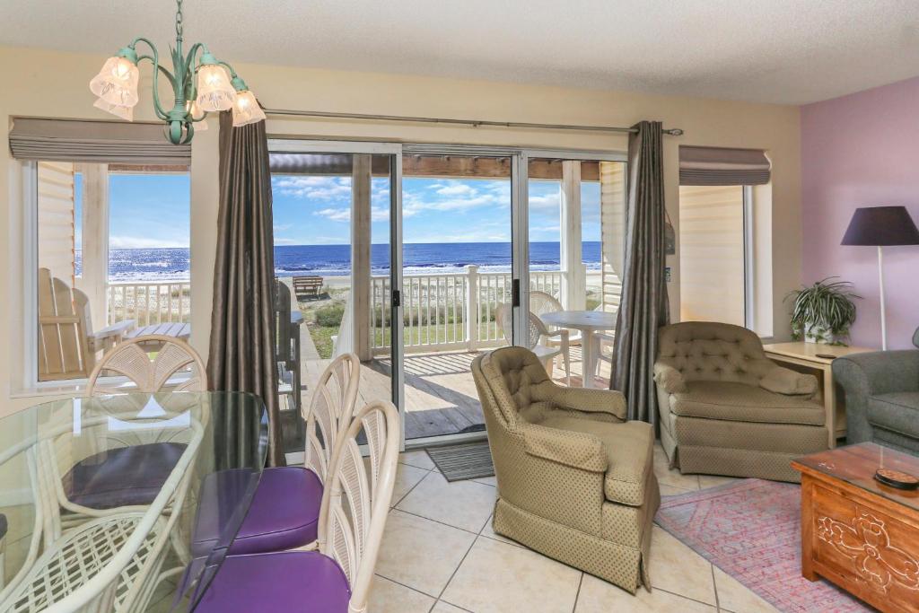 a living room with a view of the ocean at Pelican Landing 2 in Indian Pass