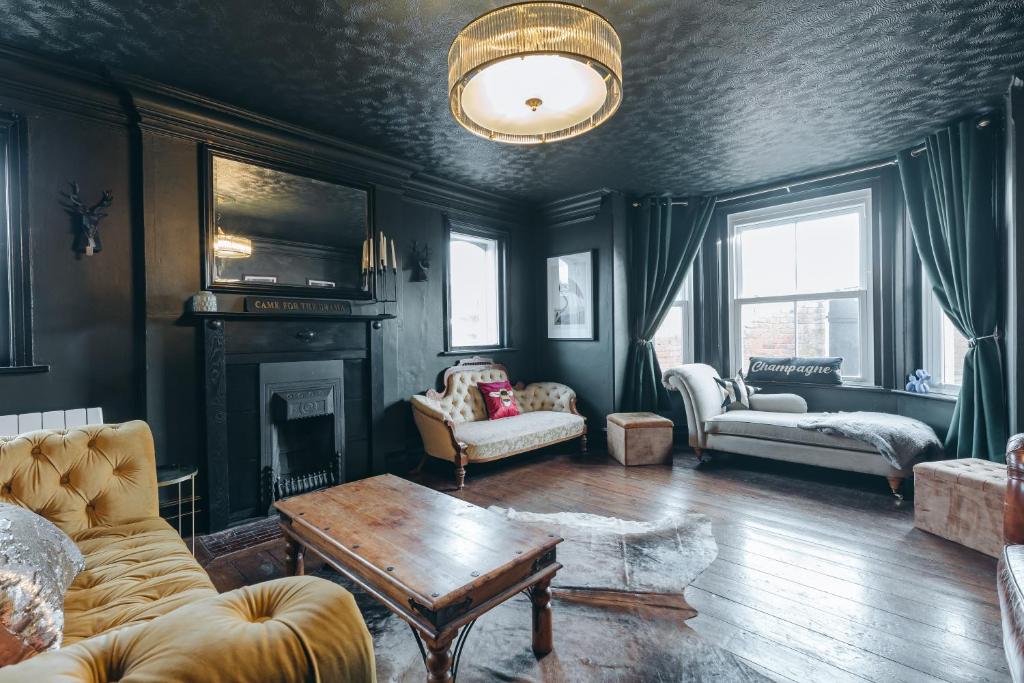 a living room with a couch and a fireplace at House with a cinema and games room, sleeps 17 in Shrewsbury