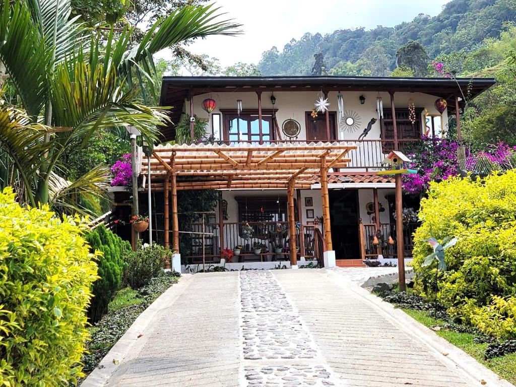 a house with a walkway in front of it at PaloSanto, Casa Rural in Jardin