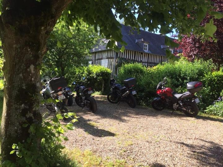 a group of motorcycles parked next to a house at Gîtes du Manoir de la Porte in Les Authieux-sur-Calonne