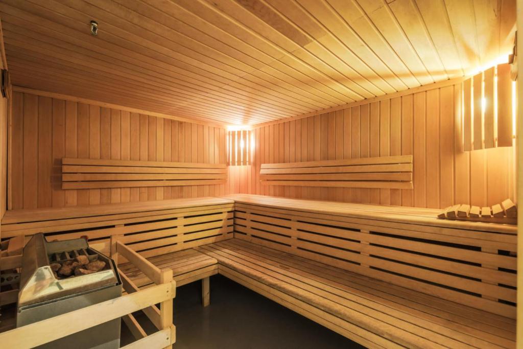 a sauna with wooden walls and benches in it at Résidence Les Temples du Soleil - maeva Home - 2 Pièces 5 Personnes Sélect 52 in Val Thorens