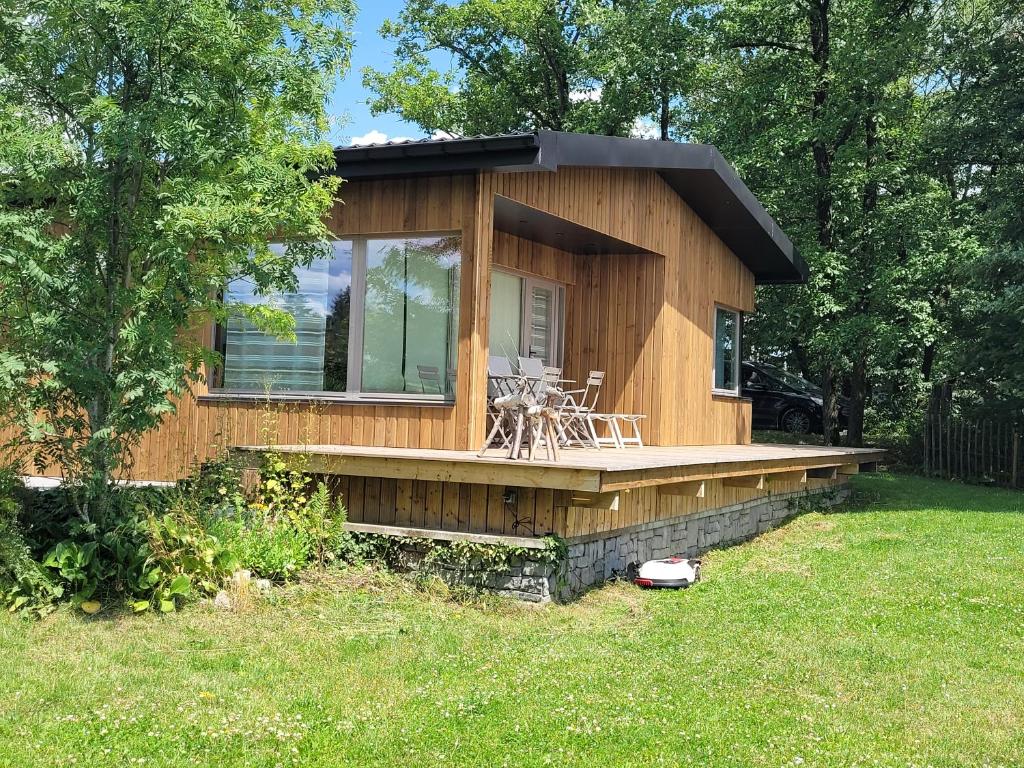 a small house with a porch and a deck at Hamerenne in Rochefort