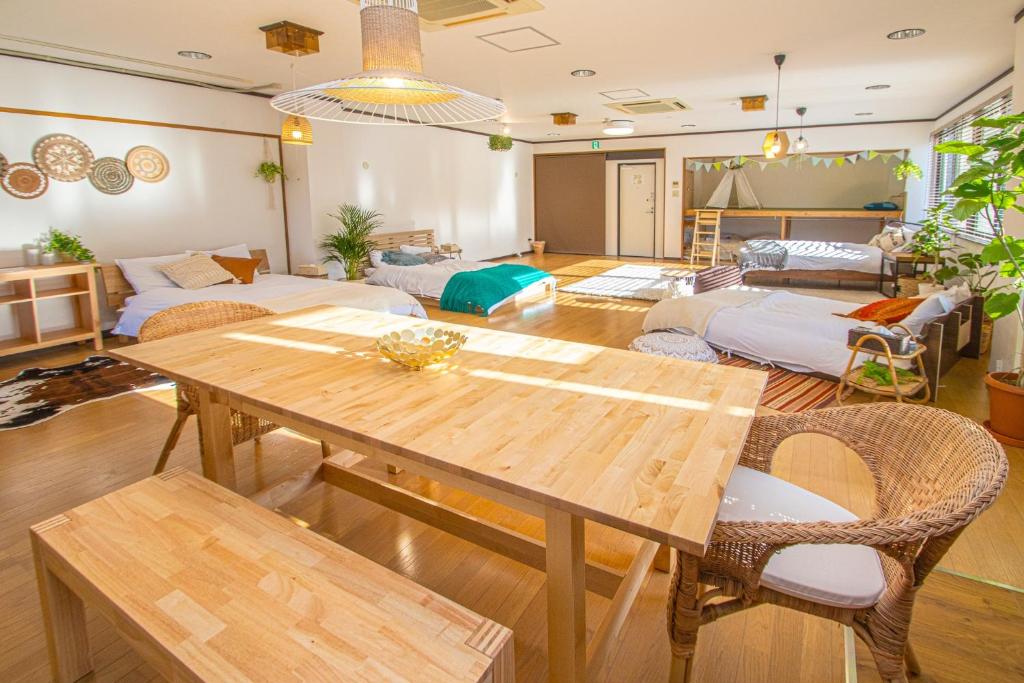 a living room with a wooden table and chairs at Gokushocho Building 3A - Vacation STAY 00195v in Fukuoka