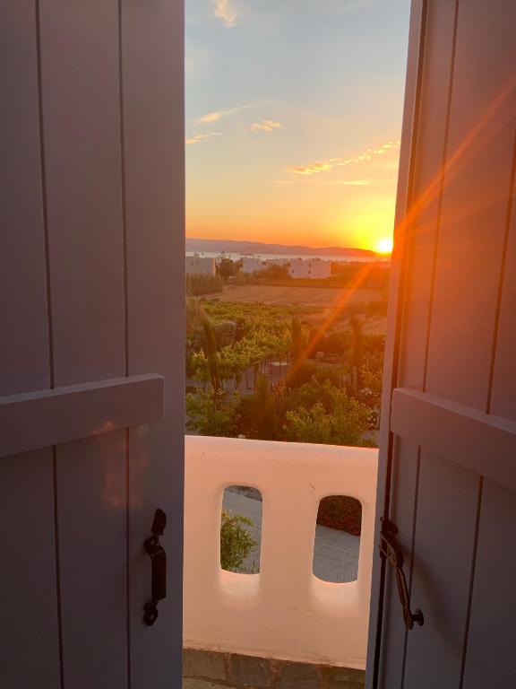 an open door with a view of the sunset at Villa Xanthos in Plaka