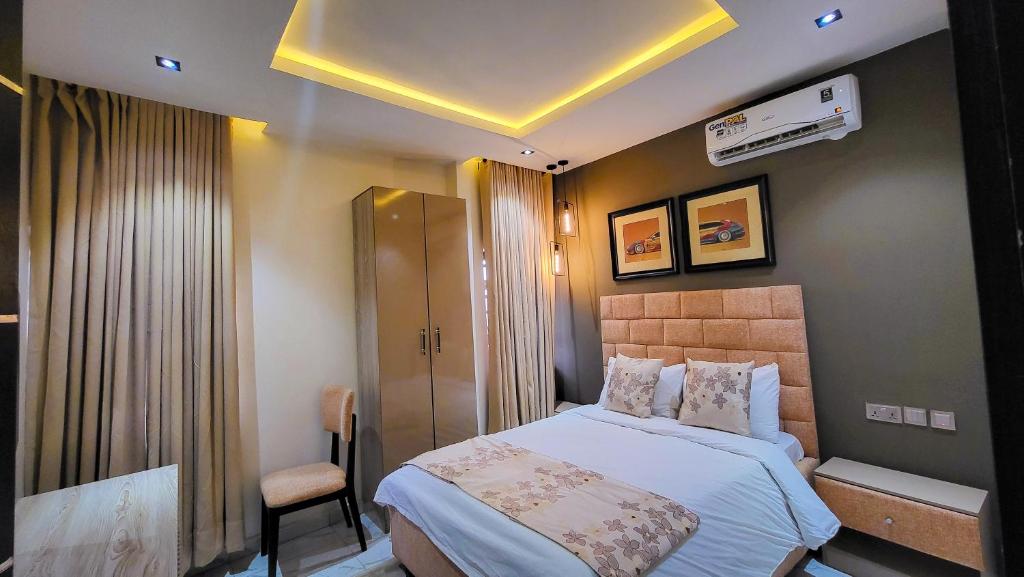 a hotel room with a bed and a chair at Abados Leisure Hotel and Lounge in Lagos