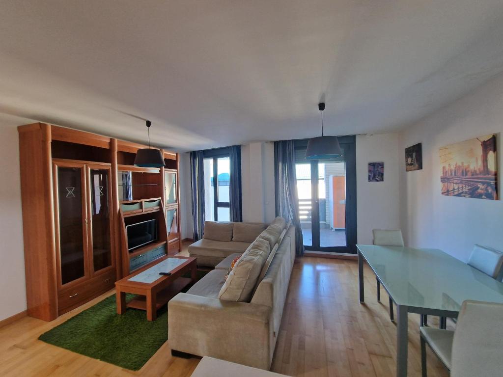 a living room with a couch and a glass table at Castro Urdiales Mioño in Mioño