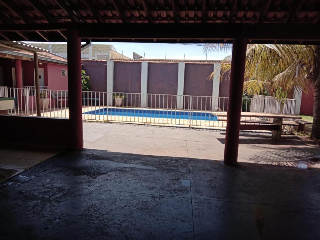 a view of a swimming pool from the inside of a building at Chácara do Lele in Ribeirão Preto