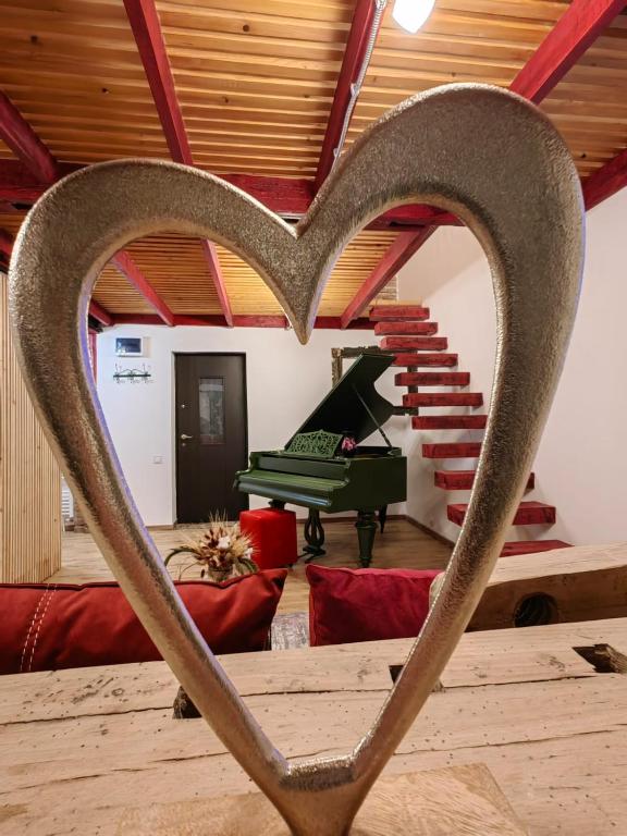 a heart in the middle of a room with a piano at Casa Anne Boutique in Braşov