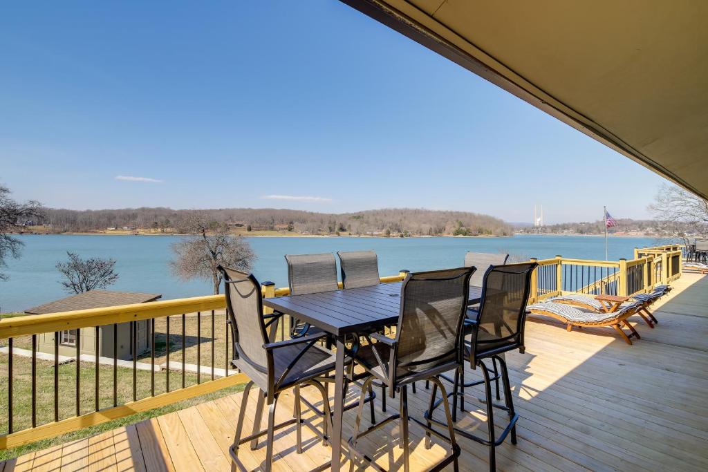 a table and chairs on a deck with a view of the water at Waterfront Kingston Apartment with River Access! in Kingston
