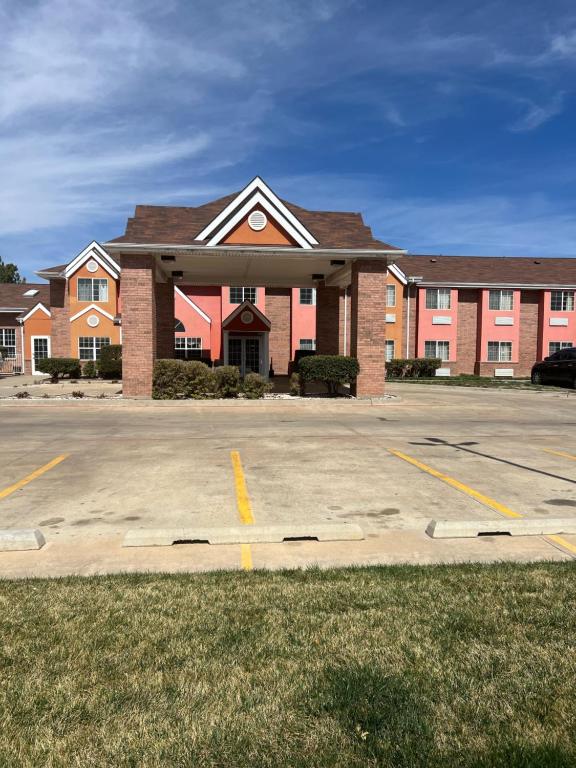 a large brick building in a parking lot at Microtel Inn & Suites by Wyndham Amarillo in Amarillo
