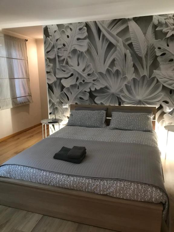 a bedroom with a large bed with a wall mural at DIMORA IL CAMMINO in San Vito al Torre