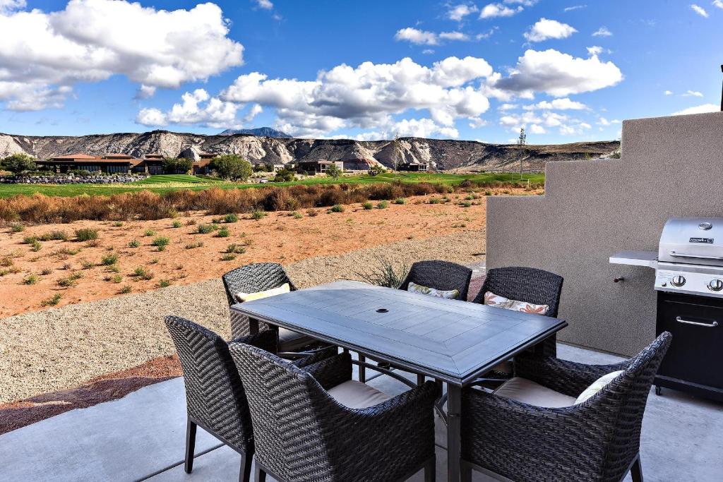 a table and chairs on a patio with a view at Another Day In Paradise in St. George