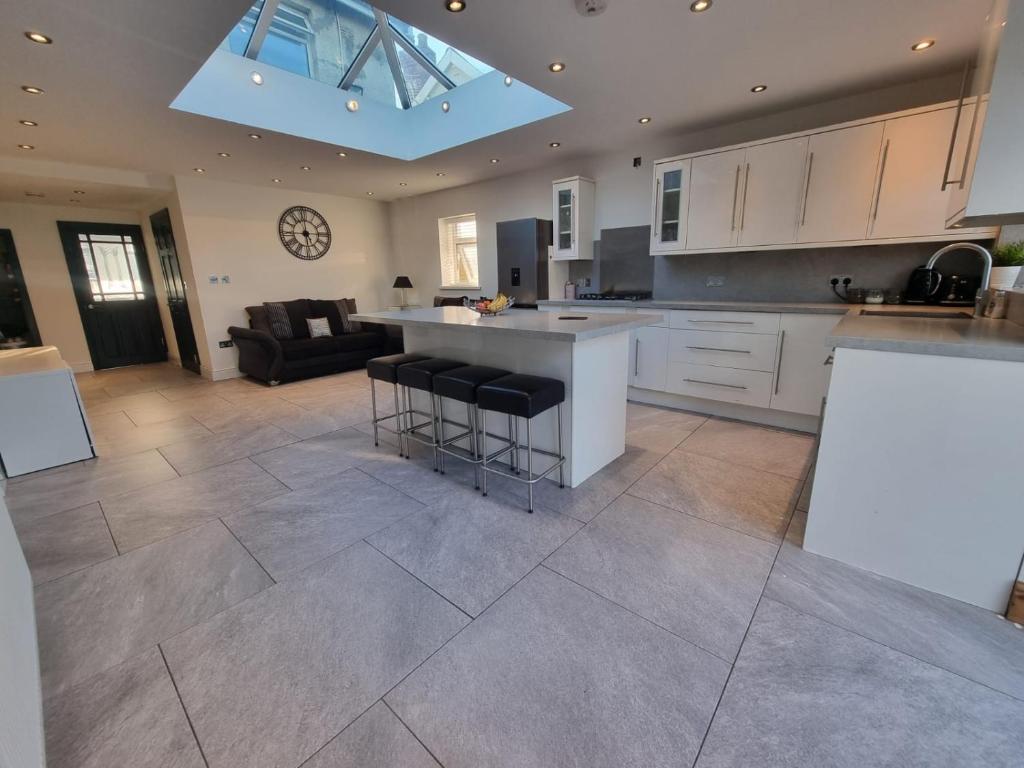 a large kitchen with a island in the middle at city centre - 2 bed house, parking for 2 in Cardiff