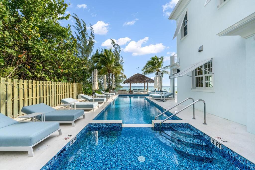 a swimming pool with lounge chairs next to a building at Kiboko in Midland Acres