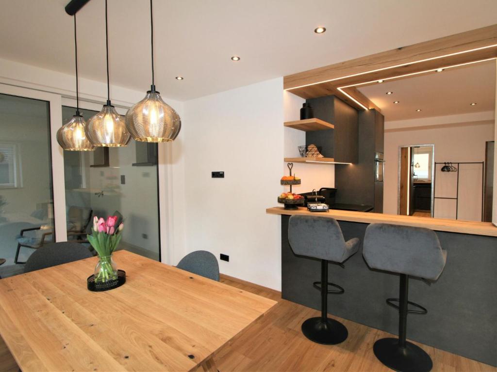 a kitchen and dining room with a table and chairs at Apartment Christine by Interhome in Brixlegg