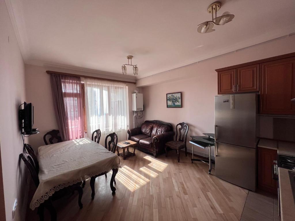 a living room with a couch and a refrigerator at Glendel hilz in Yerevan