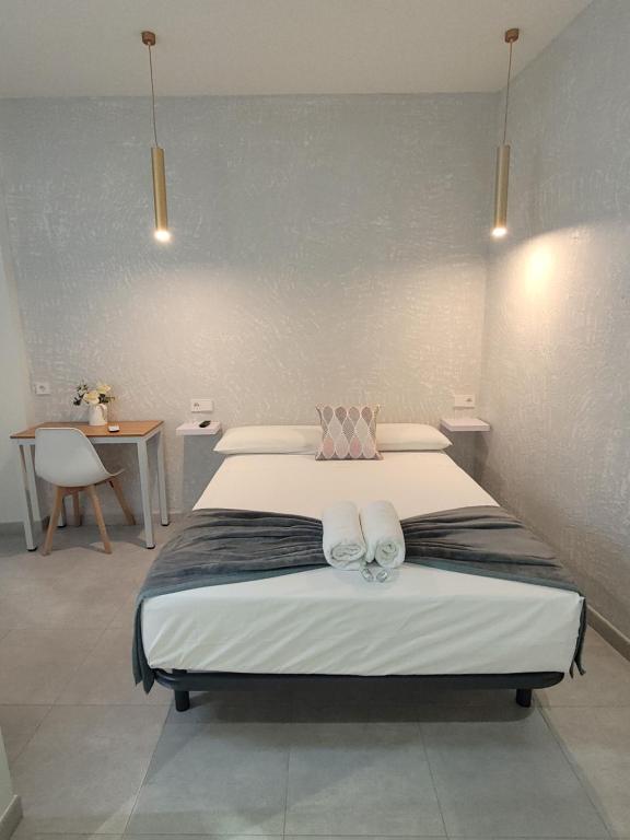 a bedroom with a bed with two towels on it at Casa Lemus in Madrid