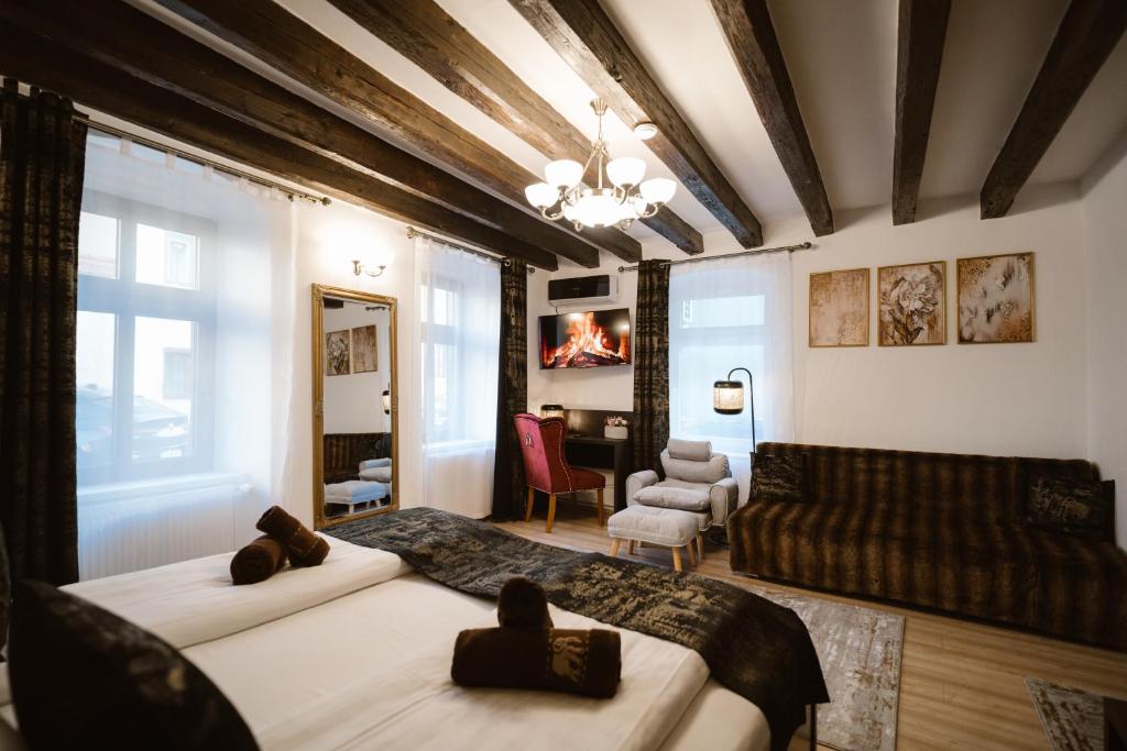 a bedroom with two beds and a living room at Hermannstadt House in Sibiu