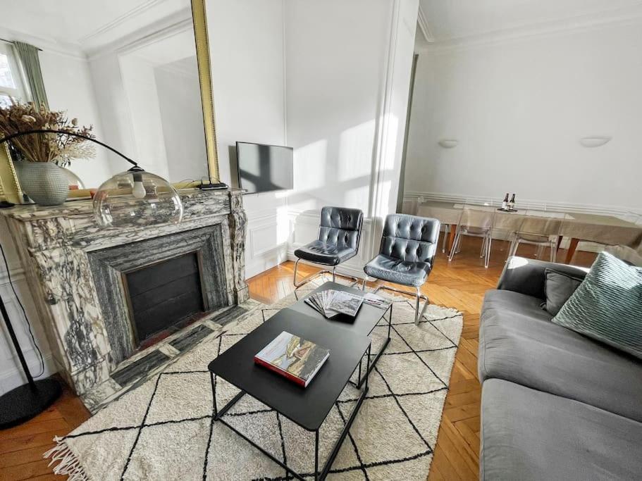 un salon avec un canapé et une cheminée dans l'établissement Les Trois Chérubins centre Dieppe plage terrasse parking privatif, à Dieppe