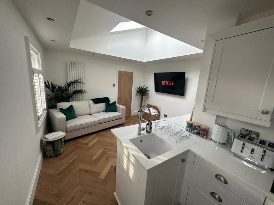a kitchen with a sink and a living room with a couch at Apartment in Barnard Castle in Barnard Castle