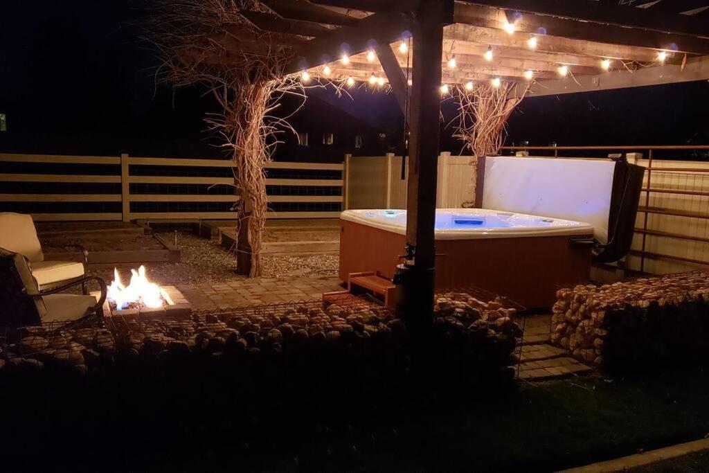 a hot tub in a backyard at night with lights at 6 King Bedrooms, Sleeps 20, 8 Rooms, Bikes, HotTub in Lindon