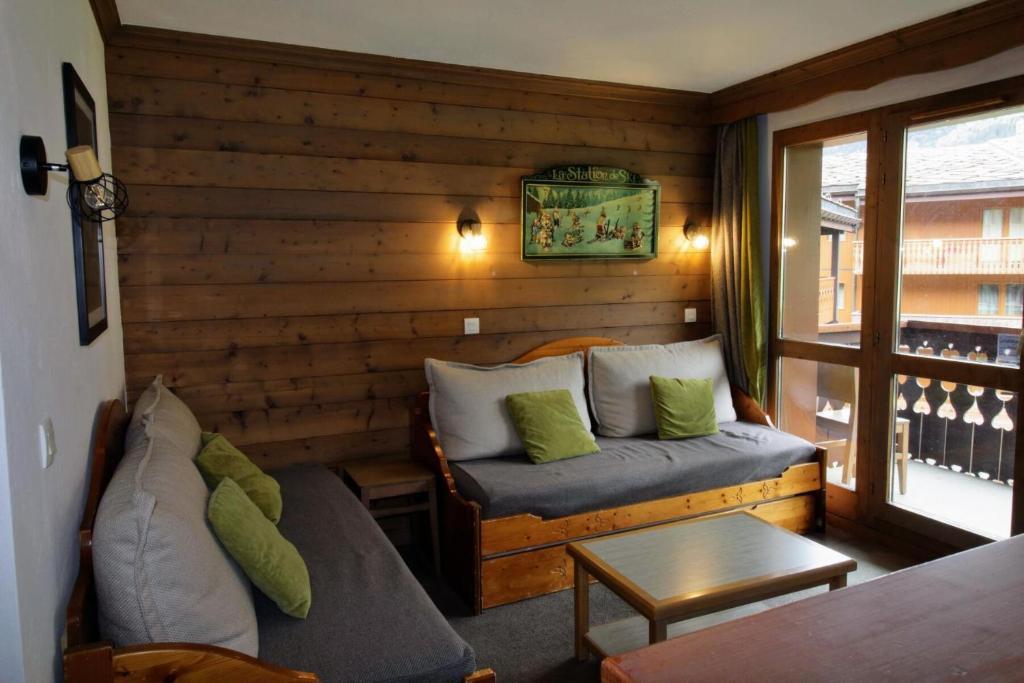a living room with a couch and a table at Quartier La Forêt - maeva Home - Appartement 3 pièces 6 personnes Sélection MAE-5126 in Valmorel