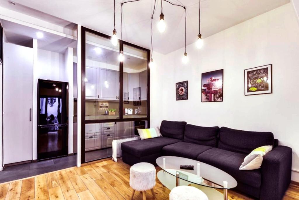 ein Wohnzimmer mit einem Sofa und einem Tisch in der Unterkunft 113 Suite Lui - Bel Appartement à Paris in Paris