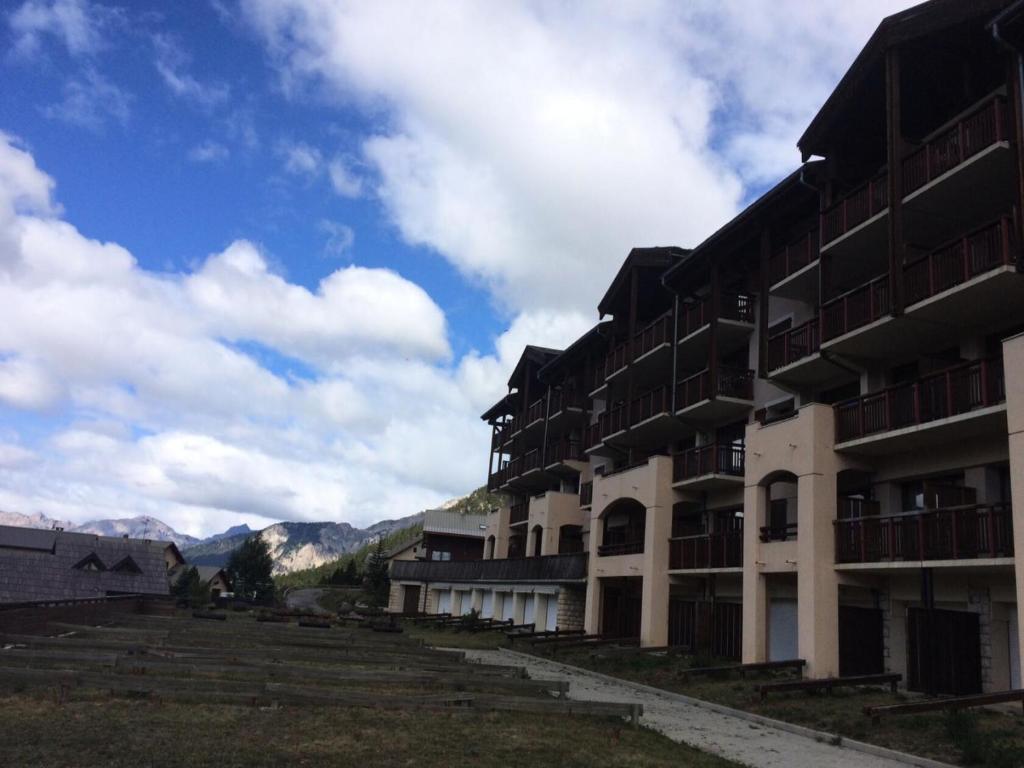 a row of buildings with mountains in the background at Résidence Plein Soleil - 2 Pièces pour 4 Personnes 004 in Montgenèvre