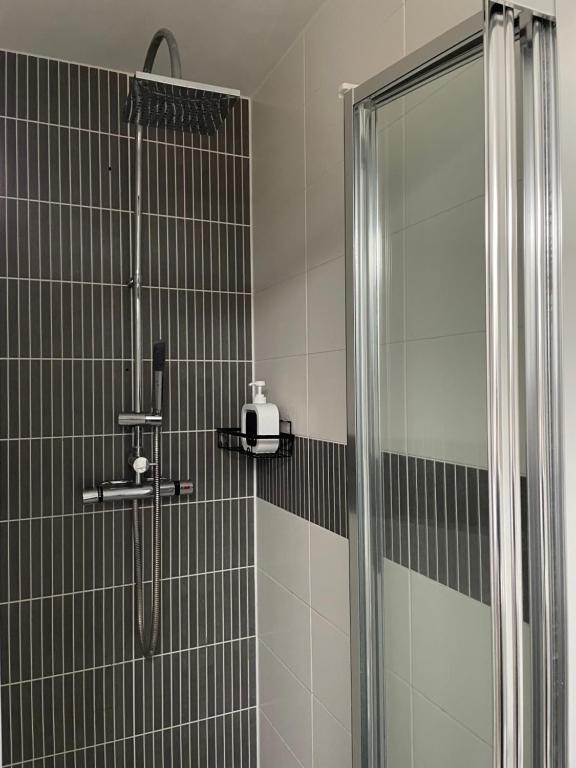 a bathroom with a shower with a glass shower backdoor at Holcott's Coach-House in Lincoln
