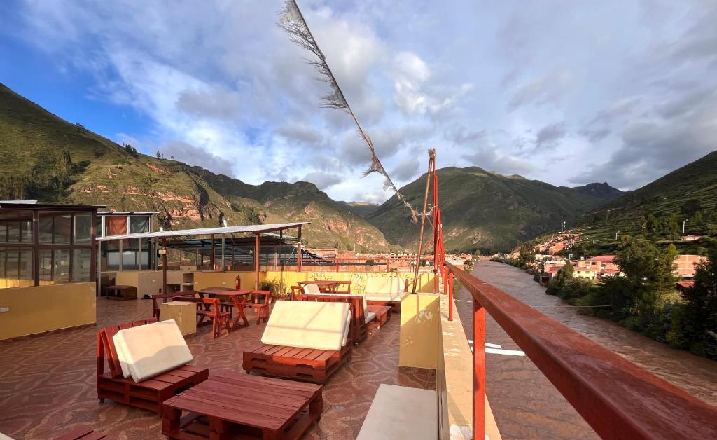 a balcony with chairs and tables on a ship at El Parche Rutero Hostel in Pisac