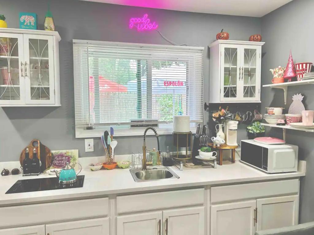 a kitchen with a sink and a microwave at Fancy studio private entrance in Selden