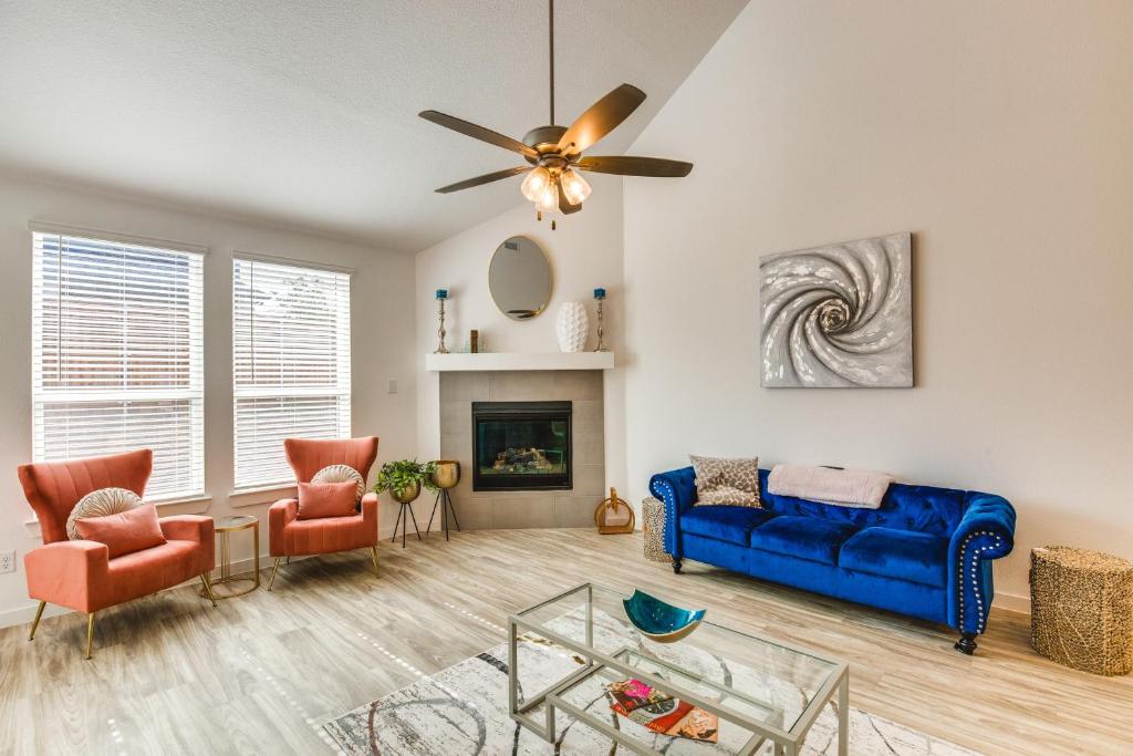 a living room with a blue couch and two chairs at Spacious Royse City Home with Community Pool Access in Royse City