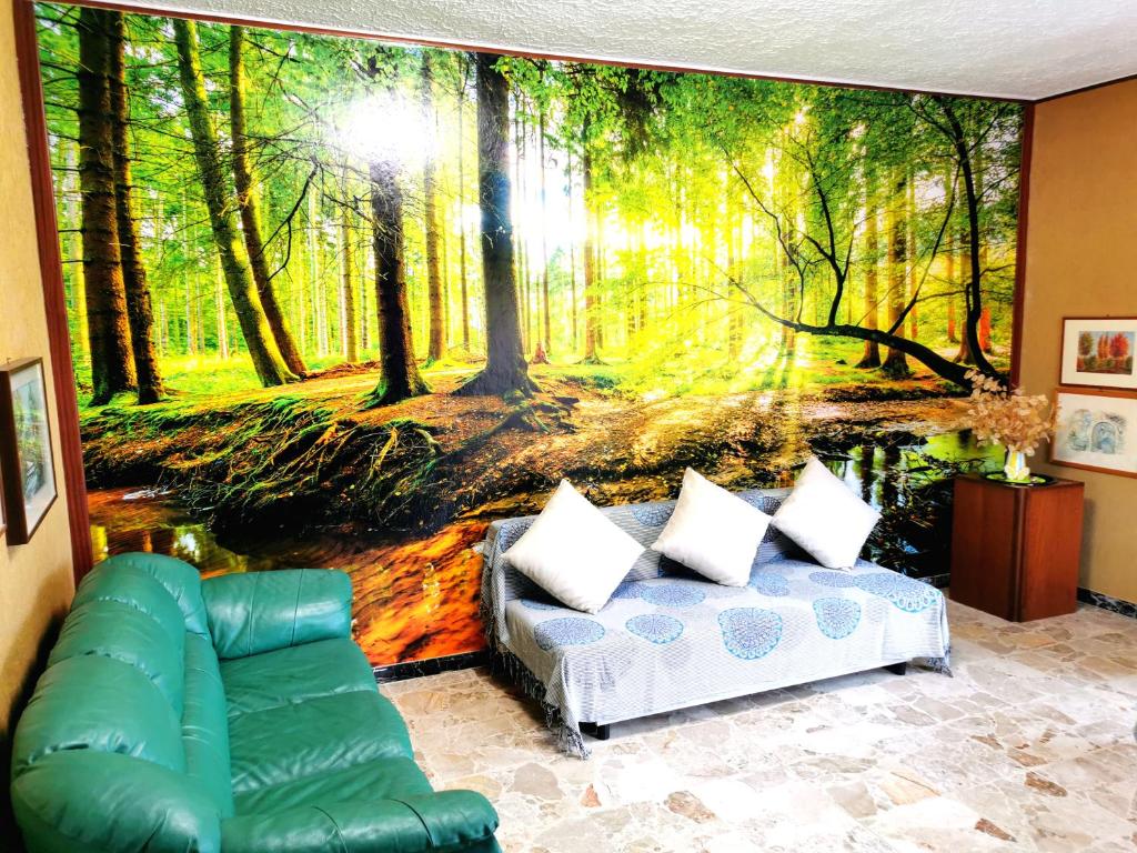 a living room with a mural of a forest at Lago Maggiore Green House in Leggiuno