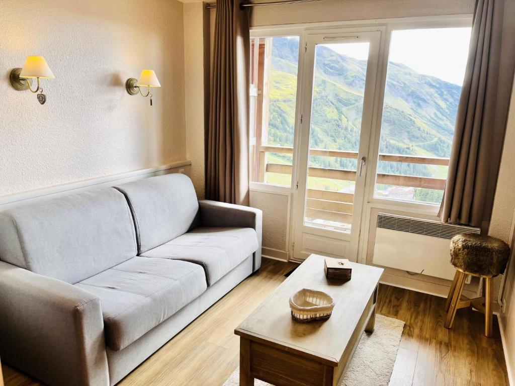 a living room with a couch and a table at Résidence Antarès - maeva Home - Appartement 2 Pièces 5 Personnes - Sélec 13 in Avoriaz