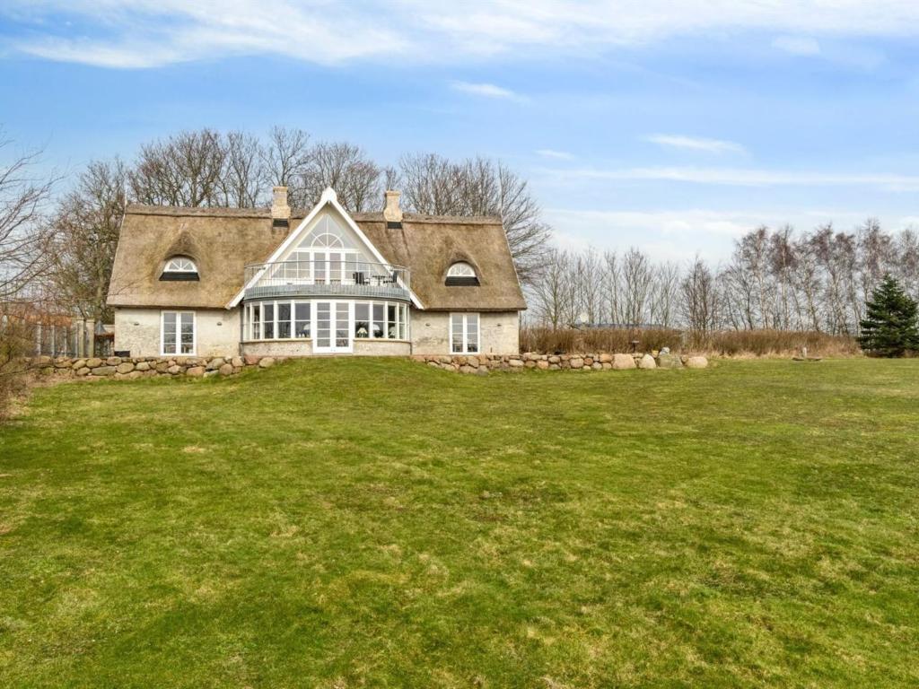 a large house on a grassy field at Holiday Home Herlek - 450m from the sea in Bornholm by Interhome in Åkirkeby