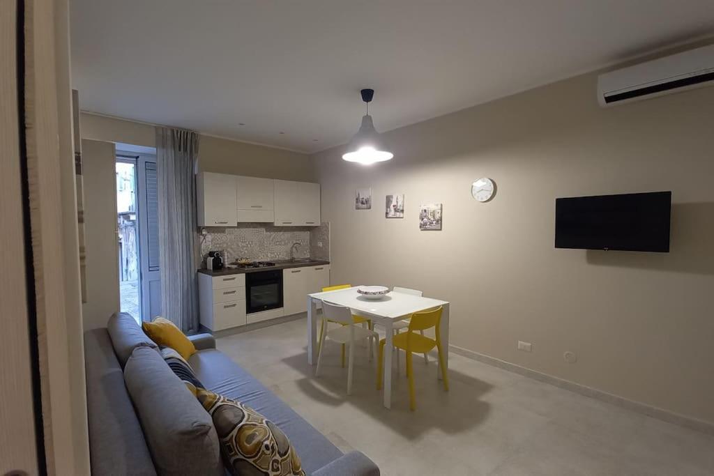 ein Wohnzimmer mit Sofa und Tisch in der Unterkunft Casa vacanza Al Cortiletto in Sortino