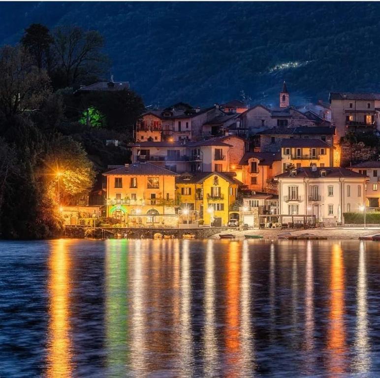 a town on the shore of the water at night at Lake & bike Mergozzo in Mergozzo