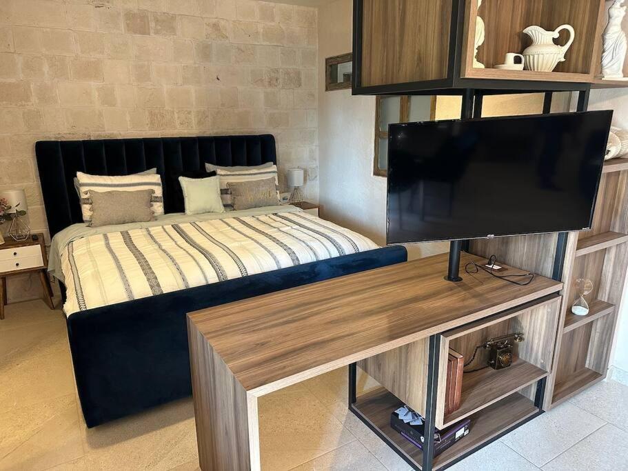 1 dormitorio con 1 cama y TV de pantalla plana en Loft Figata en Val'Quirico en Santeagueda