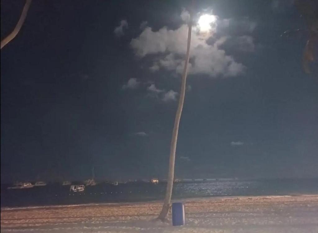 a light pole on the beach at night at Playa Coral in Punta Cana