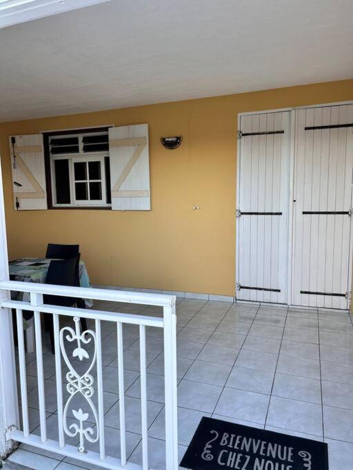 a house with two white doors and a balcony at La Maison Cocktail in Émilien
